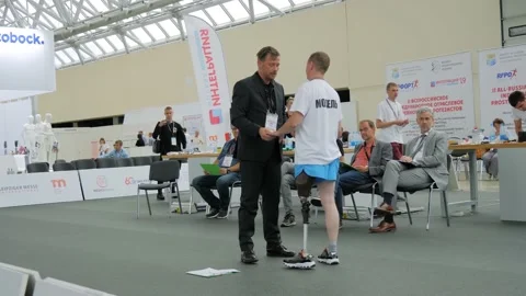 Disabled man with leg prosthesis walking in front of the jury at competition Stock Footage 149926469