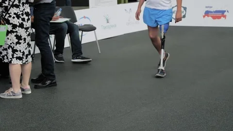 Disabled man with leg prosthesis walking in front of the jury at competition 스톡 동영상 155023760