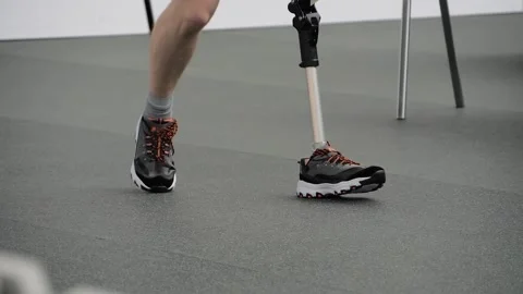 Disabled man with leg prosthesis walking at adaptive sport competition: close up Stock Footage 166830790