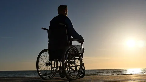 Disabled man looking to sunset silhouette panoramic slow motion Stock-Footage 89360715