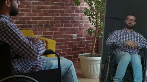 Disabled man looks in mirror stroking his beard. Appearance and beauty, self Stock Footage 159130936