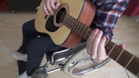 A disabled man is playing the guitar Stock Footage 202314095