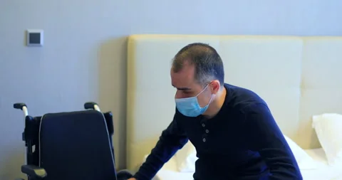 Disabled man with protective mask transferring to bed Stock-Footage 138949508