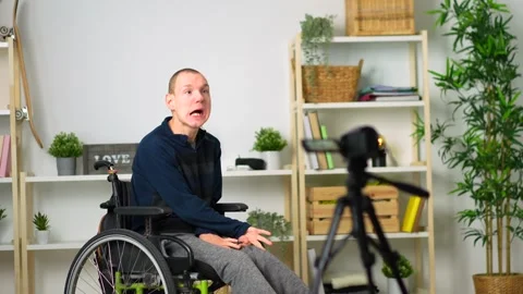 Disabled man recording a video tutorial at home 動画素材 262143201