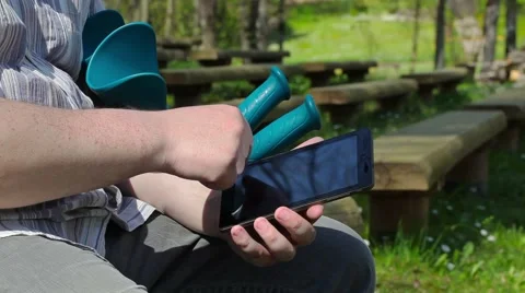 Disabled man with tablet PC and crutches on the bench Stock Footage 63007275