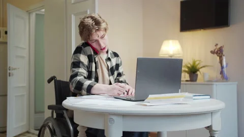 A disabled man is talking on the phone about important matters Stock Footage 163034372