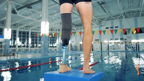 Disabled man training at a pool, bionic leg prosthesis. Stock Footage 105003387