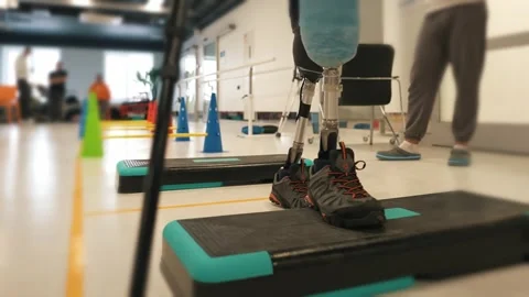 A disabled man with two leg prostheses overcomes obstacles, learns to walk on Stock Footage 264671538