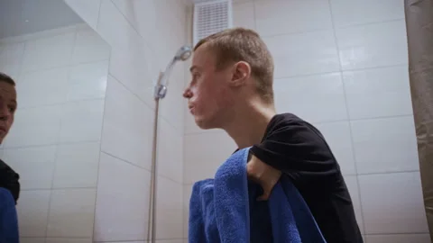 Disabled man with undeveloped hands during morning routine in bathroom Stockbeeldmateriaal 321942023
