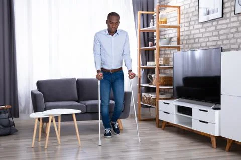 Disabled Man Using Crutches Stock Photos