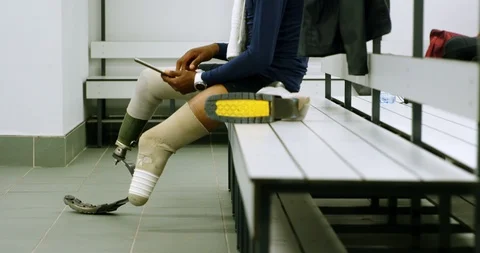 Disabled man using digital tablet in changing room 4k 動画素材 96094630