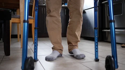 Disabled Man Walking With a Rollator Walker Ground View Stock Footage 125496260
