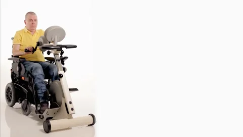 A disabled man in a wheelchair doing exercises for his hands and foots Stock Footage 233371954