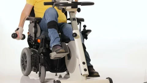 A disabled man in a wheelchair doing exercises for hands and foots Stock Footage 233371963