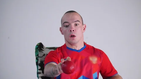A disabled man in a wheelchair. Throwing a red little ball in the air. Boccia Stock Footage 98338083