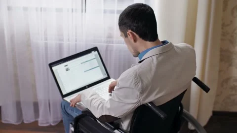 Disabled man working on laptop Stock Footage 146383041