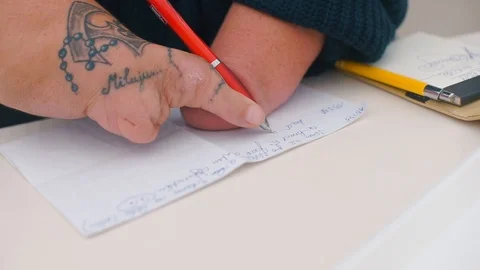 Disabled man writes a letter on paper. Stock Footage 120793784