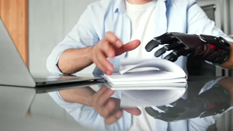 Disabled manager man with bio hand prothesis makes notes Stockbeeldmateriaal 157532809