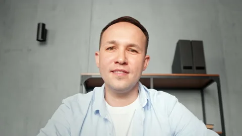 Disabled manager man waves bio limb prothesis hand online Stock Footage 157348431