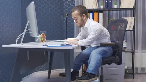 Disabled midget man stressed by his job. He works in his office. Video stock 230979813