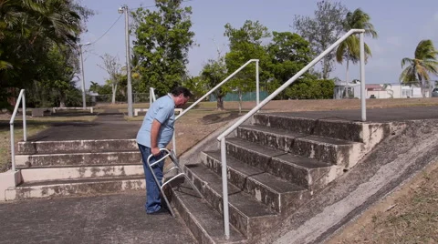 DISABLED-PARAPLEGIC man with walker and stairs 4 Stock Footage 51855849