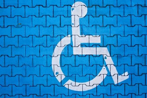 Disabled parking space, blue brick pavement road	 Stock Photos