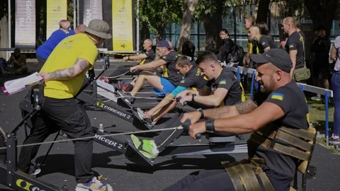 Disabled people compete on a rowing machine. Disabled war veterans play sports. Stock Footage 121559963