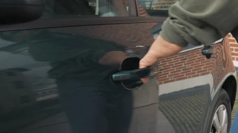A disabled person opens the car door by pulling the handle on the door. close up Stock Footage 268973260