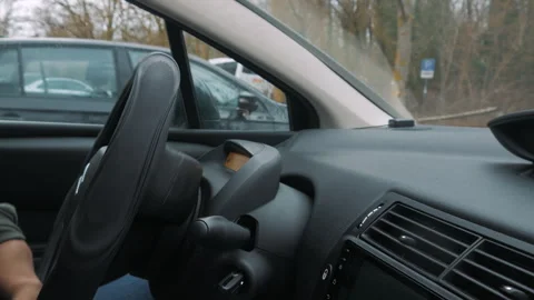 A disabled person parks a car while turning the steering wheel. Stock Footage 268976892