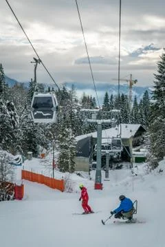 Disabled person skiing under the cable cars Stock Photos
