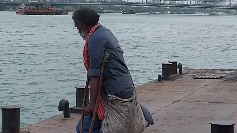A disabled person is taking help of Howrah Kolkata launch  ferry service. Video stock 178378881