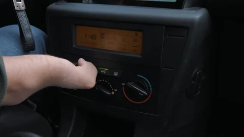 The disabled person turns on the climate control in the car. Instrument panel. Stock Footage 268975039