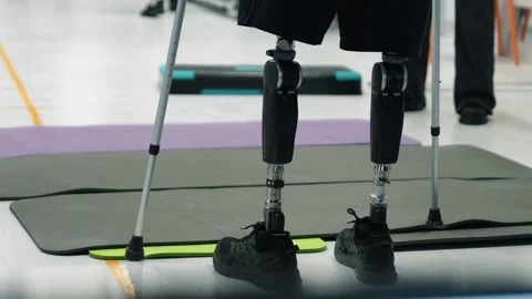 A disabled person with two leg prostheses is undergoing rehabilitation Stock Footage 263038542