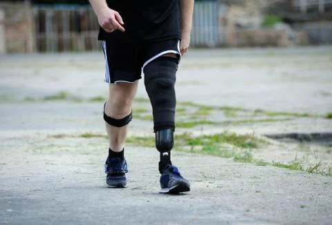 Disabled runner with artificial leg walking on a stadium Stock Photos