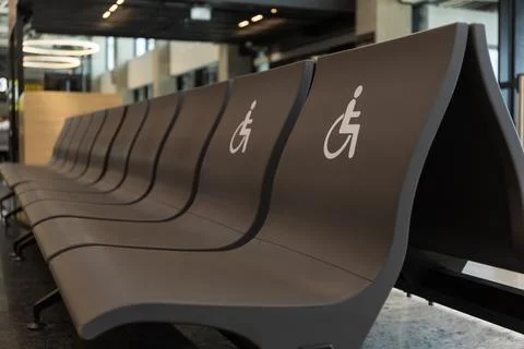 Disabled sign chairs in first row at airport waiting area Stock Photos