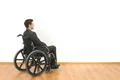The disabled sitting in a wheelchair on the white wall background Photo