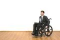 The disabled sitting in the wheelchair on the white wall background Photo