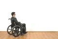 The disabled sitting in a wheelchair on the white wall background Photo
