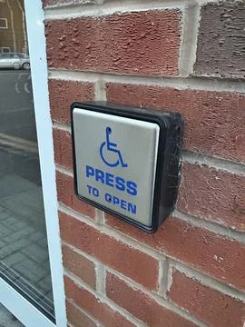 Disabled square door access button "Push to open" up close perspective Stock Photos