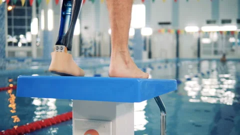 Disabled swimmer warms up near a pool, close up. Stock Footage 99535573