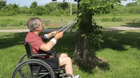 Disabled tree trimmer in a wheelchair Stock Footage 64454998
