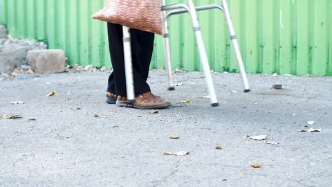 Disabled on a Walker is on the road Stock Footage 116315521