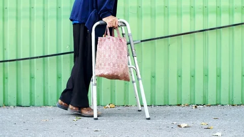 Disabled on a Walker is on the road Stock Footage 116315742