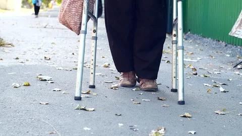 Disabled on a Walker is on the road Stock Footage 116315933