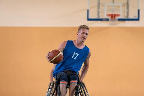 Disabled war veterans in action while playing basketball on a basketball court Stock Photos