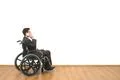 The disabled in a wheelchair phones on the white wall background Photo