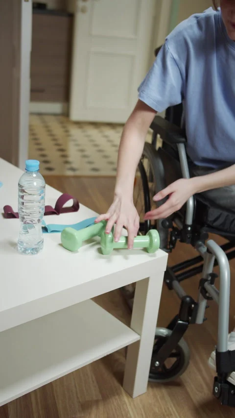 A disabled woman is making hand exercises with special equipment Stock Footage 163064897