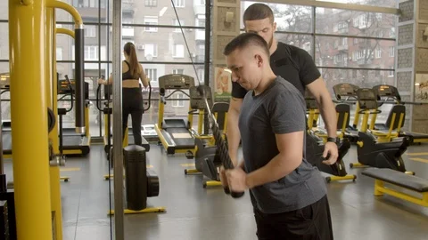Disabled young man with instructor working out in gym Stock Footage 125531976