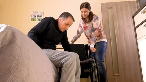 Disabled young man transferring on wheelchair Stock Footage 89619087