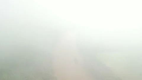 Disapearing into the clouds above beautiful forest and river. Aerial. Video stock 233218679